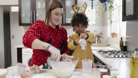 a mother and her little son baking together during