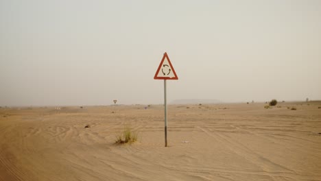 desert road with circular turn sign