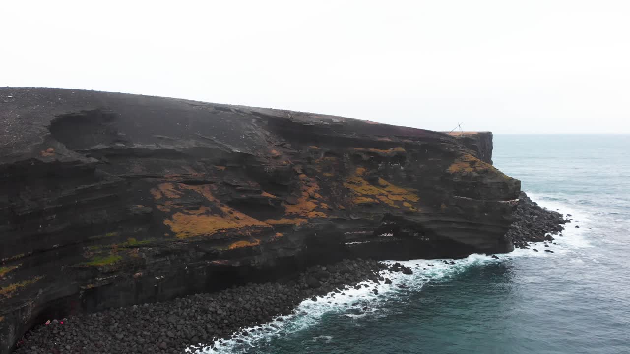 Black volcanic Kr&iacute;suv&iacute;kurberg cliffs of cold lava on coast of Iceland