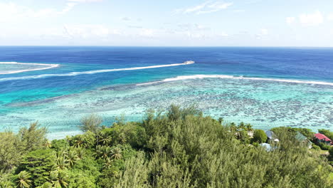 huahine island, french polynesia. aerial view of coral reefs, turquoise ocean and green coast