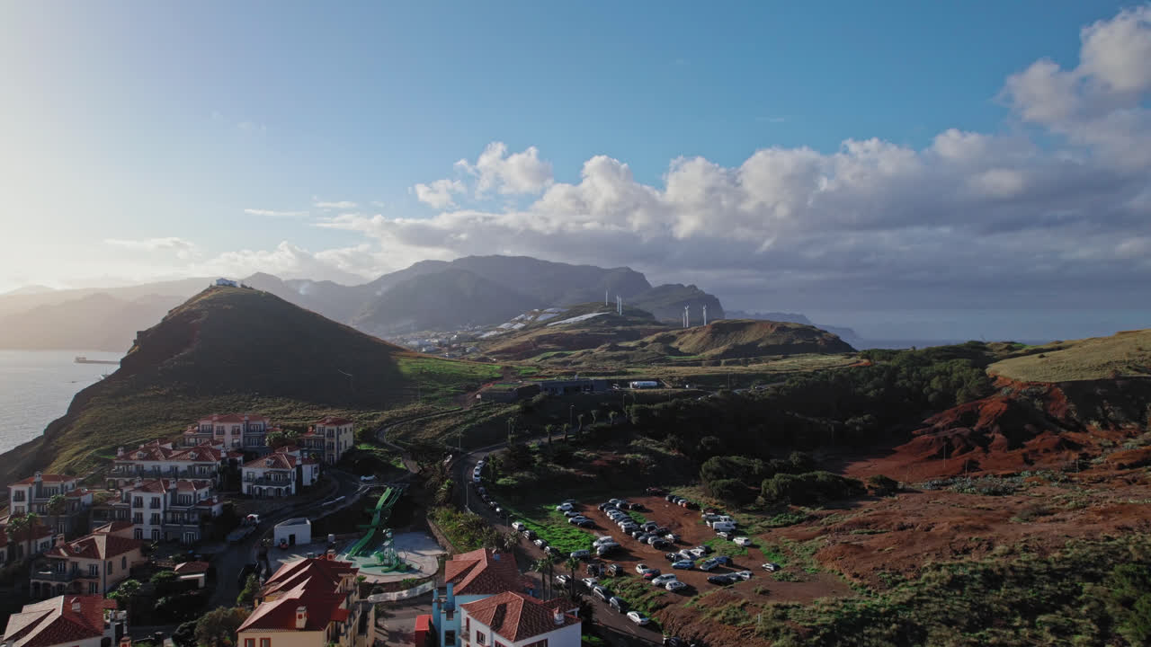 Aerial view of a coastal resort town with mountains and ocean