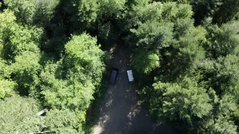 VW-Van-vintage-van-driving-through-forest-aerial-view-4k-drone