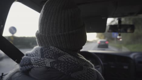 a man driving in the city in portugal in late winter afternoon