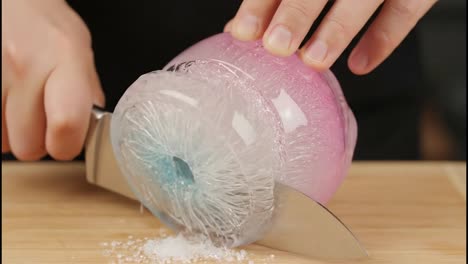 cutting a decorative ice sphere
