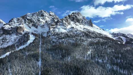 Drone-wide-Aerial-view-of-mountains-with-snow-in-winter,-Dolomites-area-in-the-north-east-of-Italy