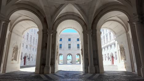 majestic symmetry of a historic courtyard archway bathed in natural sunlight. tilt down