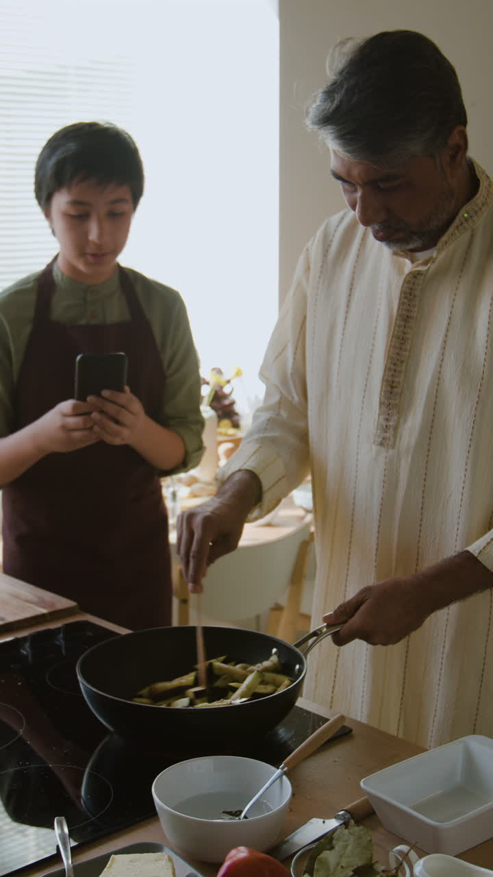 Father and Son Cooking Together in the Kitchen