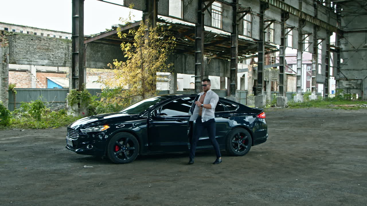 Young brutal man with gun. Brutal man with gun ready to shoot outdoor