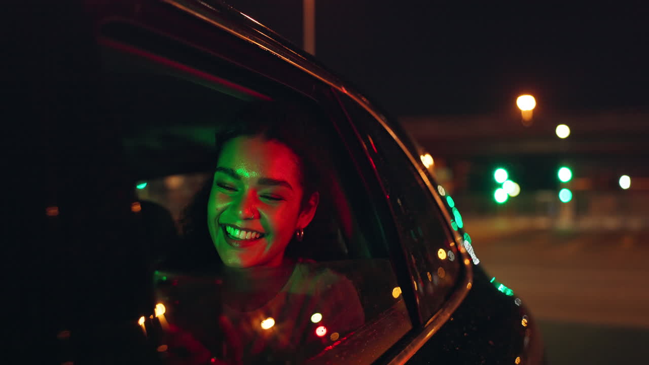 Woman smiling in car at night