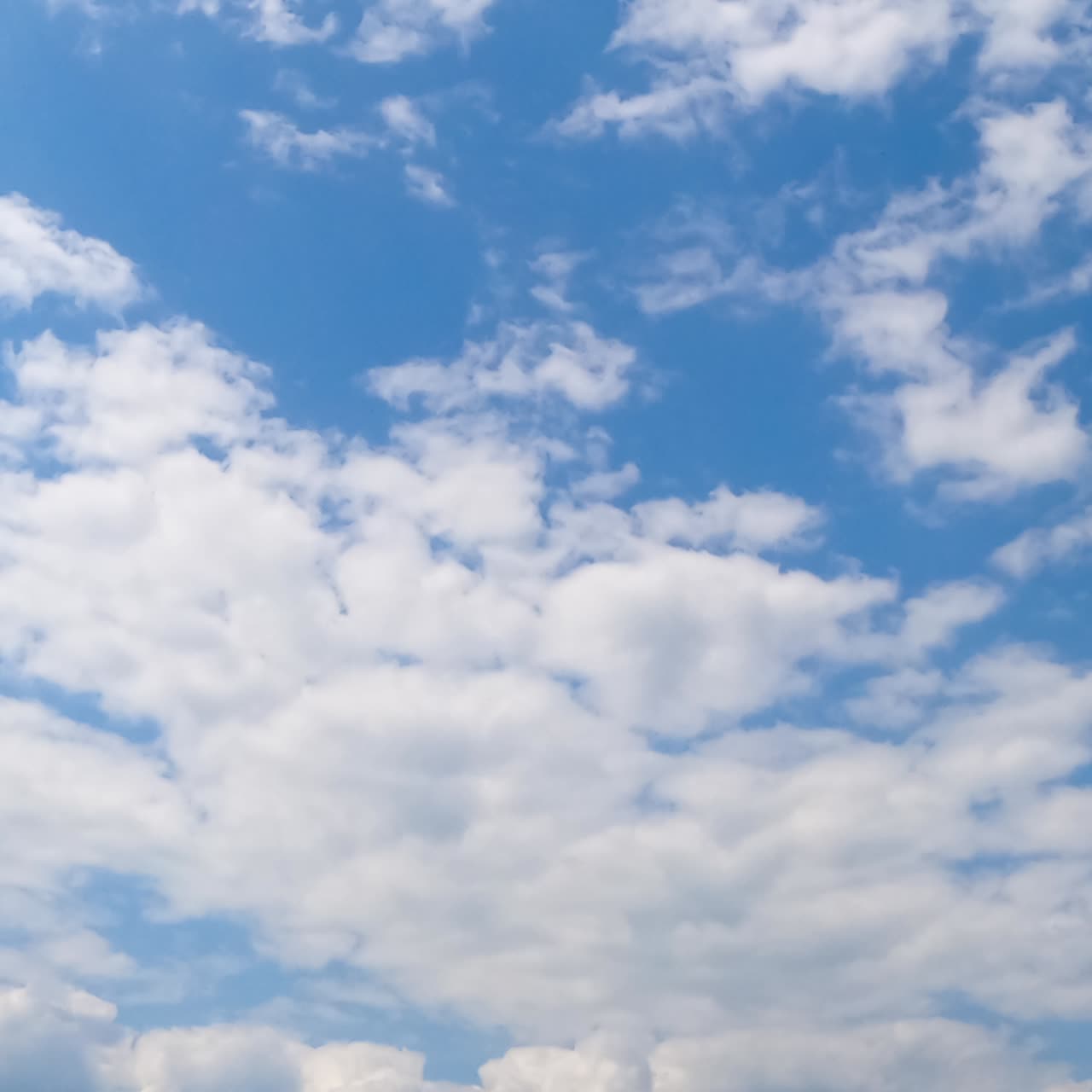 White cloudscape transformation in the atmosphere. Big and small cotton clouds moving from low angle view. Timelapse