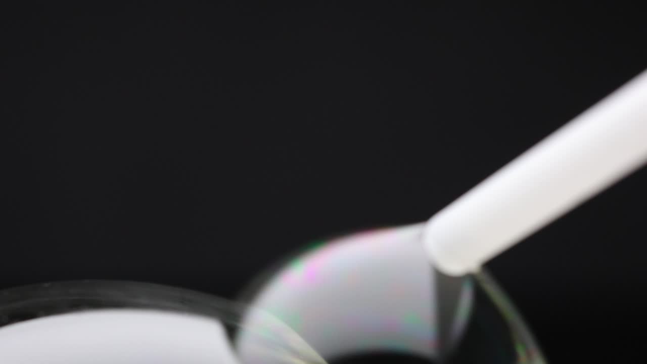 Vibrant soap bubbles display swirling colors and reflections against a dark background, creating a mesmerizing visual effect