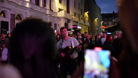 myles crossley sings with a smile on his face and tourists join him