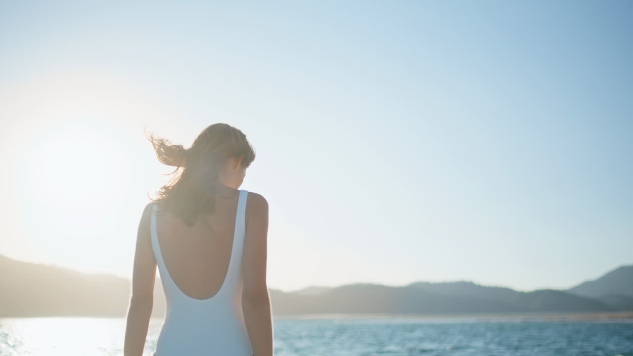Woman feet walking shore by ocean waves closeup. Relaxed lady leaving footprints