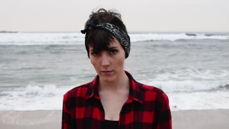 Woman-standing-on-wet-sand-on-beach