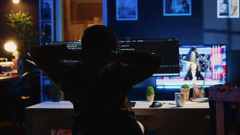 man doing it support job from home office, stretching after sitting at desk