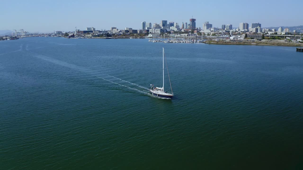 A beautiful sailboat slowly streams along toward the camera.