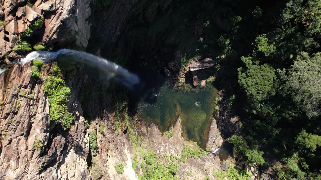 aerial video of waterfall in Chapada dos Veadeiros, Cachoeira Simão Correia, Alto Paraíso de Goiás, with rainbow, green well, sunny day