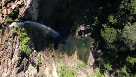 aerial video of waterfall in chapada dos veadeiros, cachoeira simão correia, alto paraíso de goiás, with rainbow, green well, sunny day