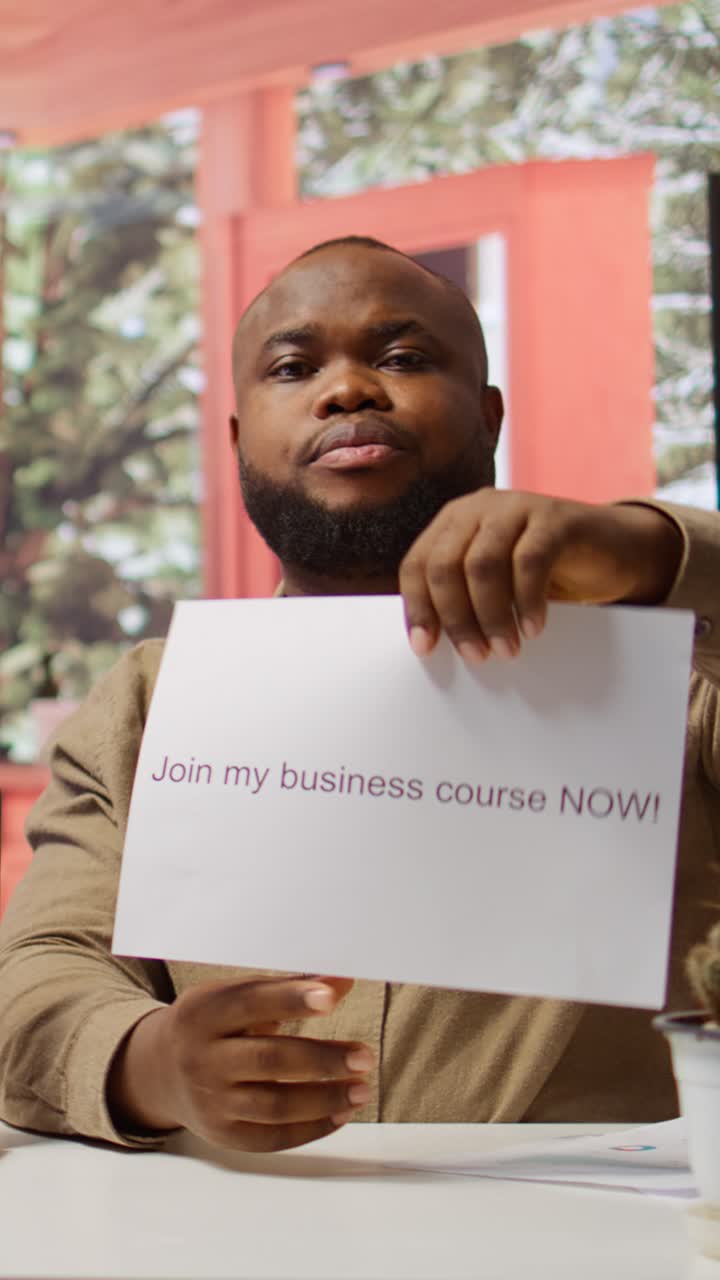 African American Man Promoting Business Course with Sign