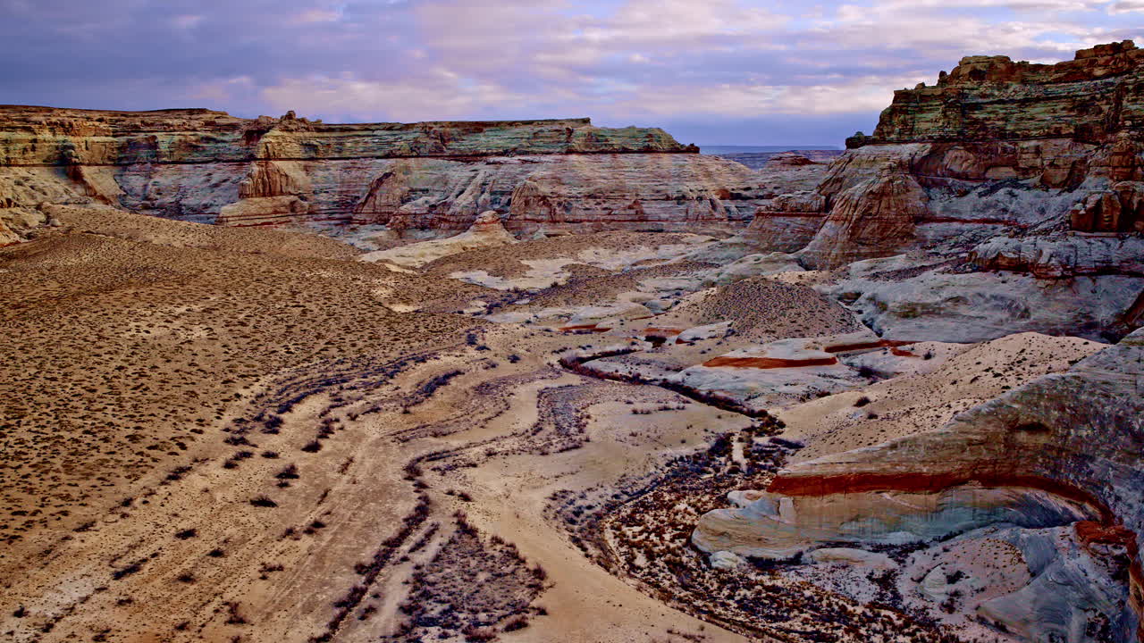 A drone elegantly glides over Glen Canyon, capturing the unique eroded rock formations near Page, Arizona.