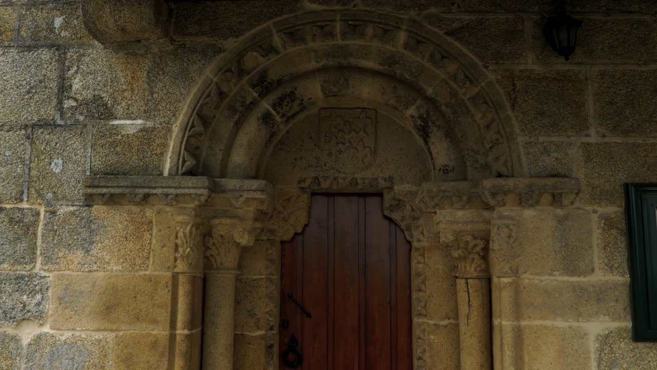 Close up of Santiago de Gustei church entrance, focusing on stonework and historical design