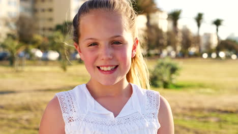 girl child, park and smile on face in sunshine