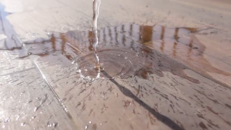 water splashing on wood floor