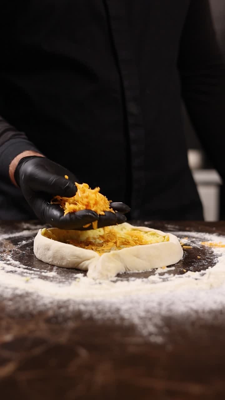 chef preparando una pizza con topping de queso