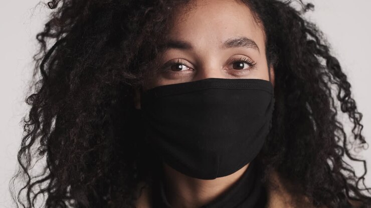 Mujer afroamericana mirando a cámara.
