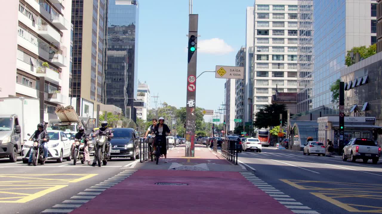 Cyclist on a Bike Lane in a Busy City Street