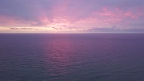 picturesque landscape of pink sunset over calm ocean