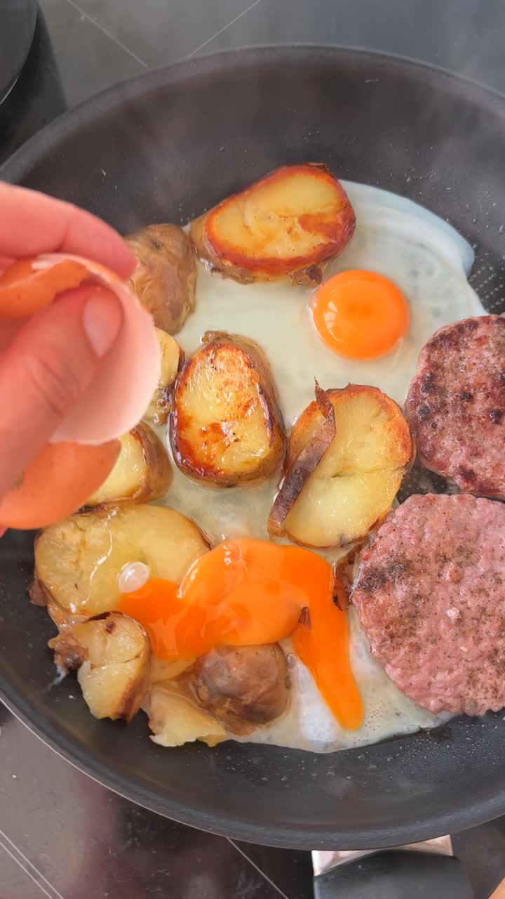 Cracking an Egg into a Frying Pan with Breakfast Items