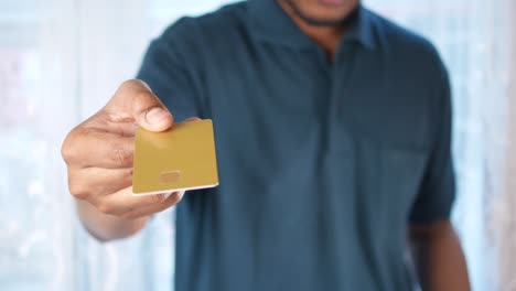 man in casual dress showing credit card