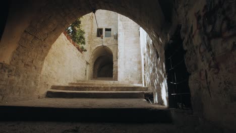 wide shot dolly right, nablus old city alley in west bank palestine, old traditional arabic alley. urban sprawl. 4k