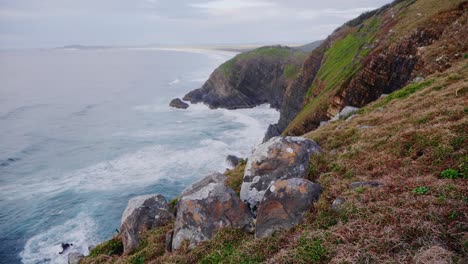 ocean waves crashing against the cliffs - crescent head during summer - sydney, new south wales, australia