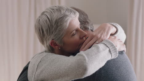 sad mature woman hugging husband sharing bad news to emotional wife couple embracing stressful retirement marriage problems 4k footage