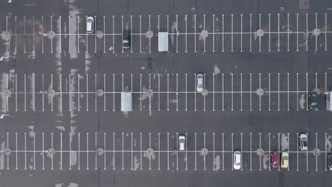 aerial: a few cars parked in a parking space with plenty of empty space