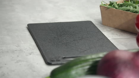 select focus closeup: orbiting small cutting board on kitchen counter