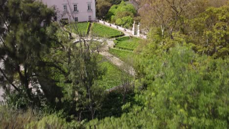 Aerial-Forward-Flying-Over-Beautiful-And-Historical-Park-In-Downtown-Lisbon,-Portugal