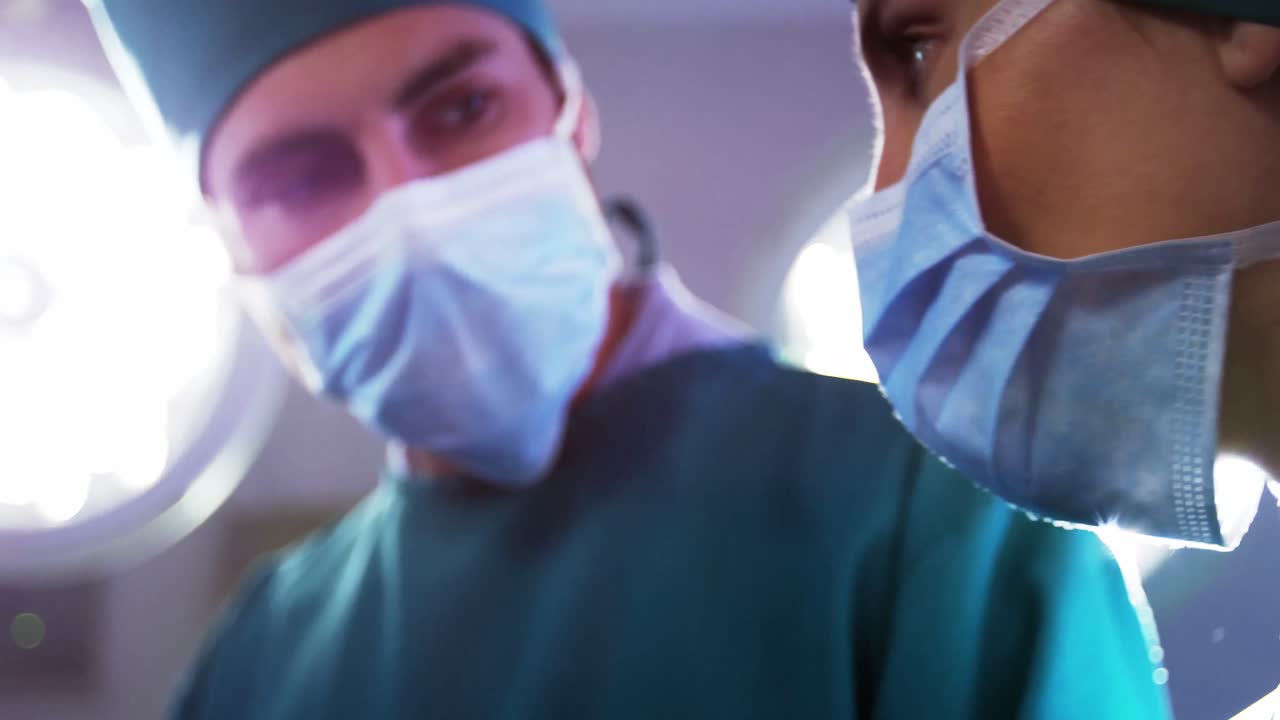 equipo médico interactuando entre sí mientras realizan la operación