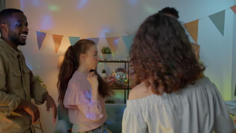 friends dancing at a party at home