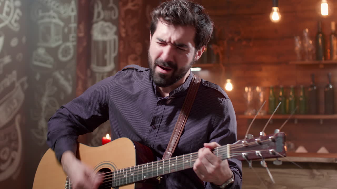 Man playing guitar in a bar