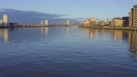city skyline reflected in calm river