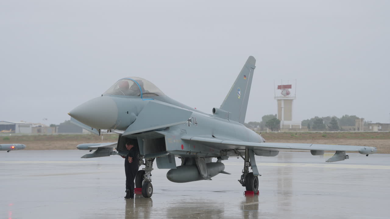 Eurofighter Typhoon Jet on Tarmac with Ground Crew on a Cloudy Day