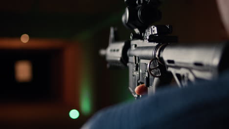 man holds rifle, enjoying shooting experience in firing range, close up