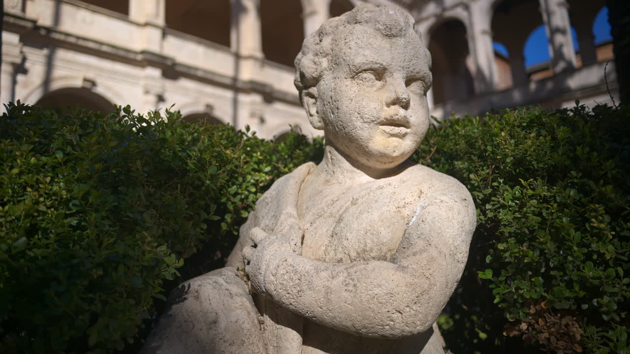 A cherub in the garden of the Basilica of St Mark Evangelist at Campidoglio. Rome, Italy