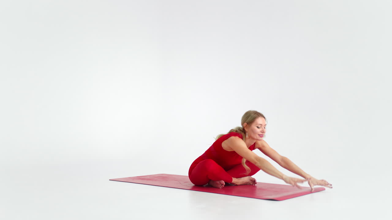 Young woman shows yoga or pilates exercises. Young attractive woman practicing yoga in studio. Girl shows different poses for yoga in white background. Healthy lifestyle yoga in my heart sports