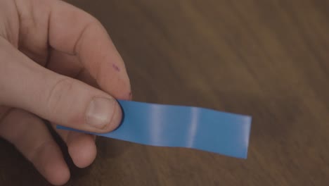 Handling-a-strip-of-electric-tape-in-slow-motion