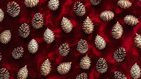 golden pine cones on red velvet