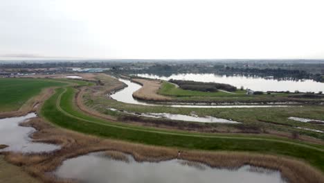 Aerial-drone-shot-of-the-River-Stour-through-farmland-in-Kent,-England